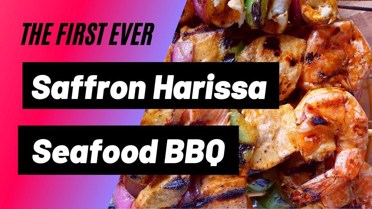 Close-up of grilled seafood BBQ with shrimp, fish, and vegetables alongside bold text announcing Saffron Harissa Seafood BBQ
