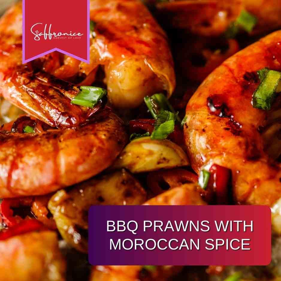 Close-up of BBQ prawns seasoned with Moroccan spice and garnished with green herbs and red chili slices