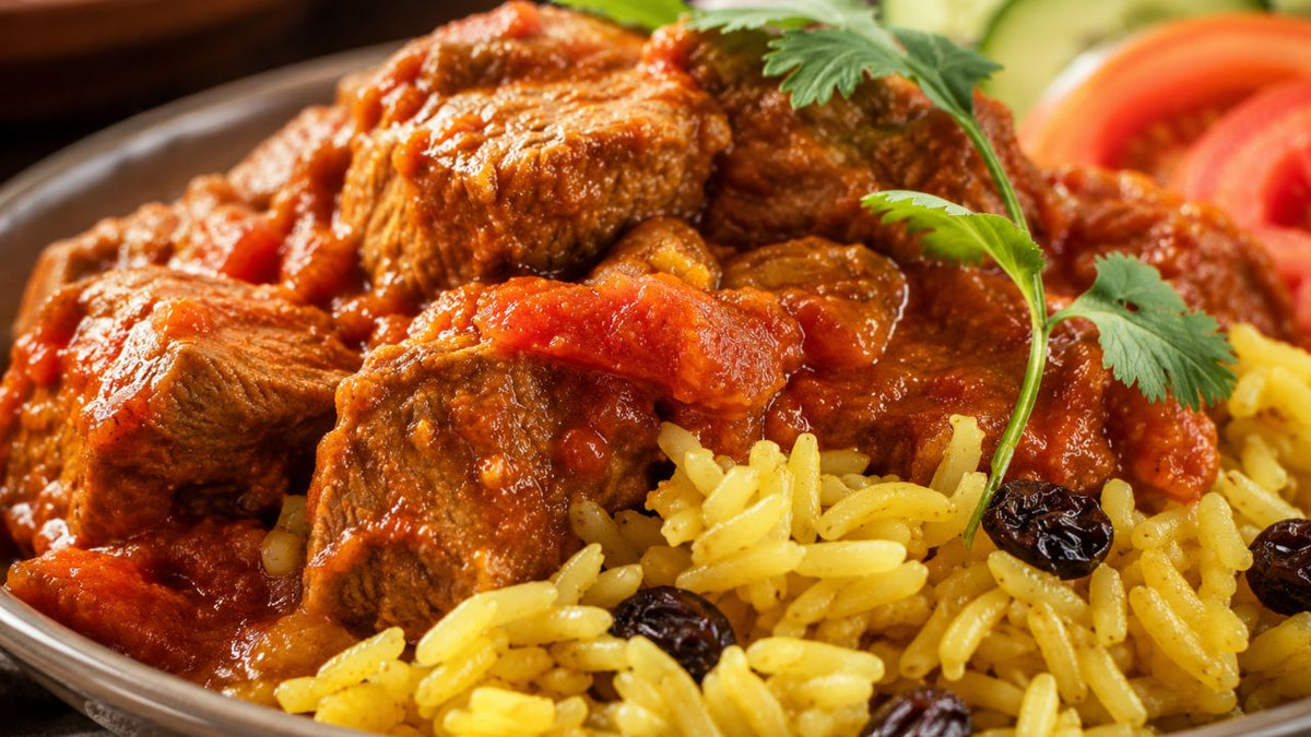 Beef vindaloo served with saffron rice and garnished with fresh coriander.