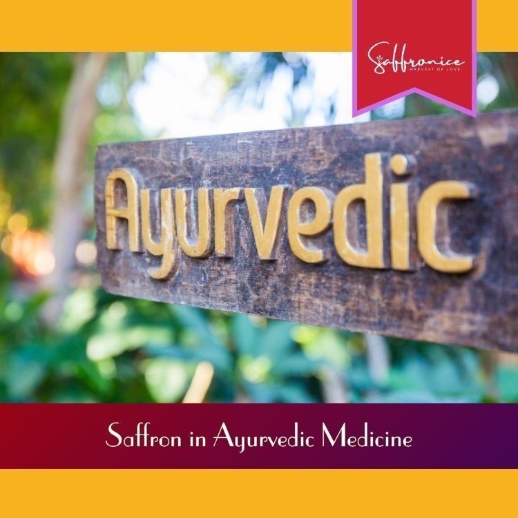 Wooden sign with golden Ayurvedic text surrounded by green plants, highlighting saffron in Ayurvedic medicine